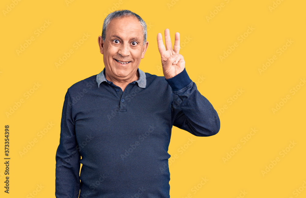 Senior handsome man wearing casual polo showing and pointing up with fingers number three while smiling confident and happy. Senior handsome man wearing casual polo showing and pointing up with fingers number three while smiling confident and happy.