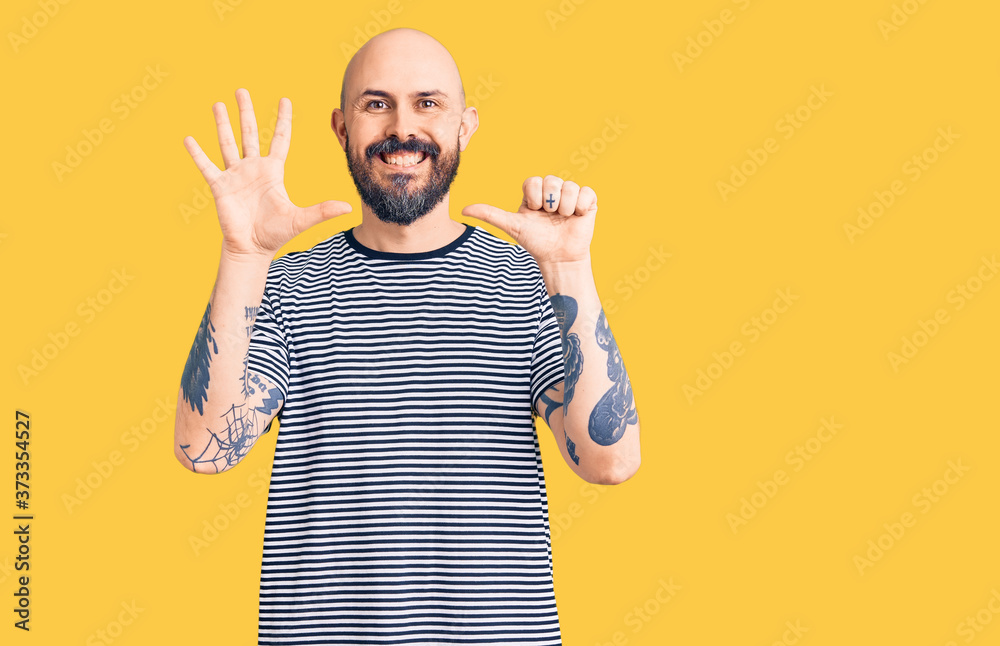 Naklejka premium Young handsome man wearing casual clothes showing and pointing up with fingers number six while smiling confident and happy.