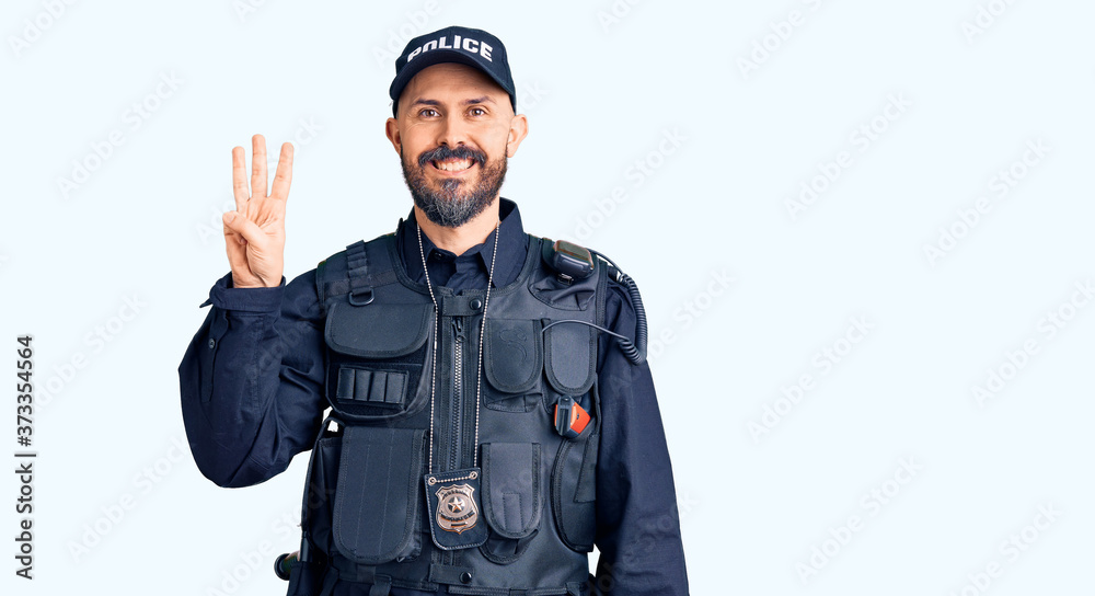 Young handsome man wearing police uniform showing and pointing up with fingers number three while smiling confident and happy. Young handsome man wearing police uniform showing and pointing up with fingers number three while smiling confident and happy.