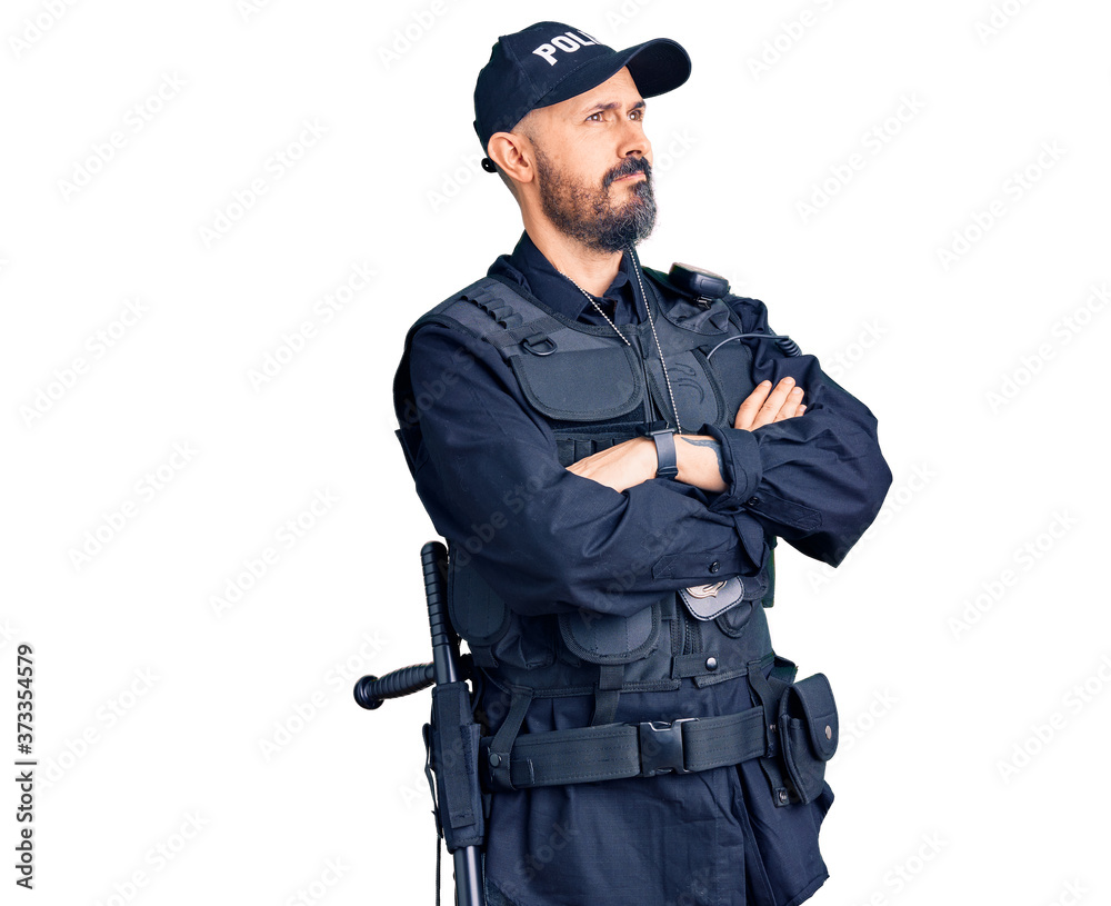 Young handsome man wearing police uniform looking to the side with arms crossed convinced and confident Young handsome man wearing police uniform looking to the side with arms crossed convinced and confident