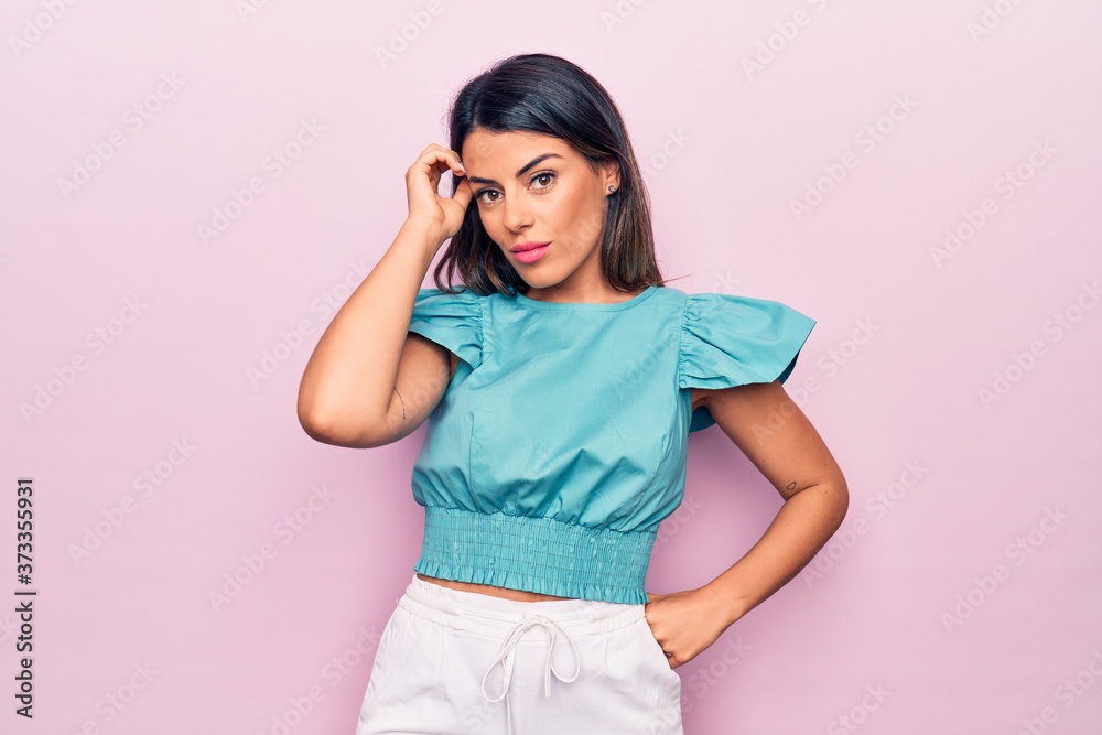 Young beautiful brunette woman standing over isolated pink background Young beautiful brunette woman standing over isolated pink background