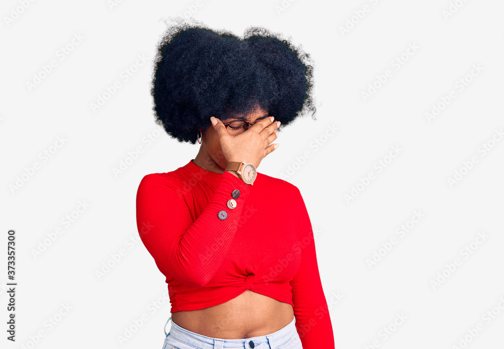 Young african american girl wearing casual clothes and glasses tired rubbing nose and eyes feeling fatigue and headache. stress and frustration concept. Young african american girl wearing casual clothes and glasses tired rubbing nose and eyes feeling fatigue and headache. stress and frustration concept.