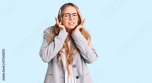 Photos Young beautiful blonde woman wearing call center agent headset covering ears with fingers with annoyed expression for the noise of loud music