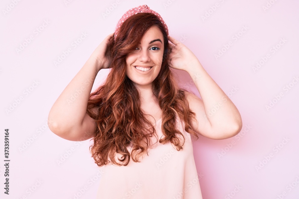 Young beautiful woman wearing casual clothes relaxing and stretching, arms and hands behind head and neck smiling happy Young beautiful woman wearing casual clothes relaxing and stretching, arms and hands behind head and neck smiling happy