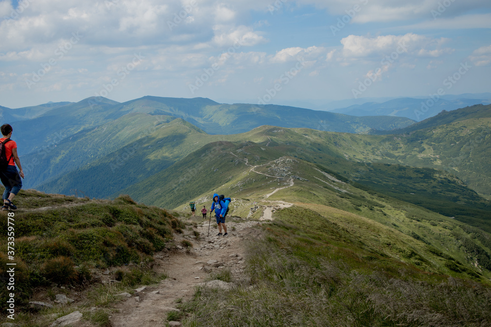 Hiker on the top in Carpathians mountains. Travel sport lifestyle concept