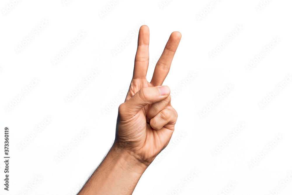 Hand of caucasian young man showing fingers over isolated white background counting number 2 showing two fingers, gesturing victory and winner symbol Hand of caucasian young man showing fingers over isolated white background counting number 2 showing two fingers, gesturing victory and winner symbol
