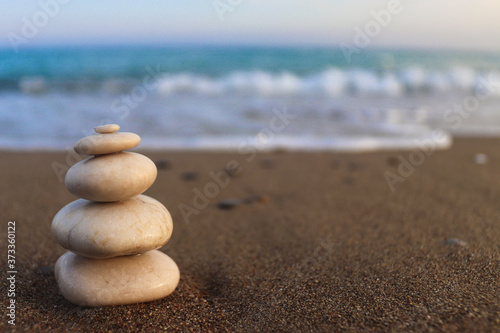 Pyramid of stones on the seashore. Zen concept. Concept of harmony  stability  life balance  relaxation and meditation. Blurred background  copy space for text  selective focus