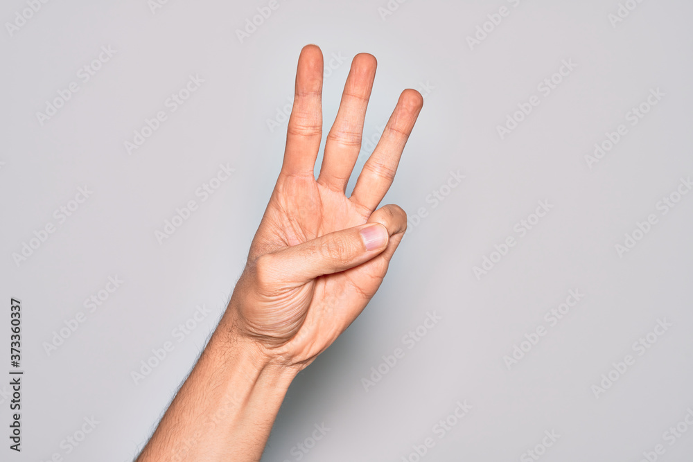 Hand of caucasian young man showing fingers over isolated white background counting number 3 showing three fingers Hand of caucasian young man showing fingers over isolated white background counting number 3 showing three fingers