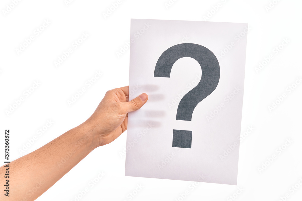 Hand of caucasian young man holding paper showing question mark over isolated white background Hand of caucasian young man holding paper showing question mark over isolated white background