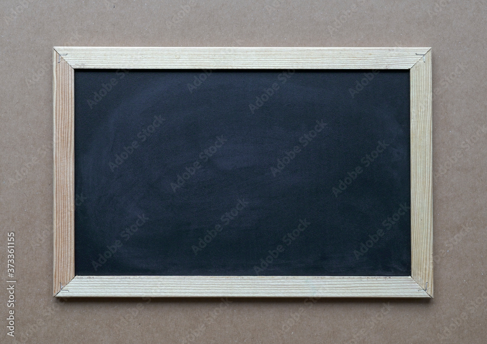 Blank blackboard on brown carrdboard background Blank blackboard on brown carrdboard background