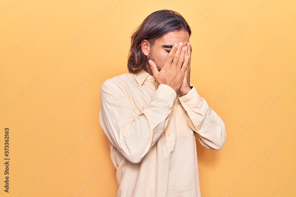 Young handsome man wearing business clothes with sad expression covering face with hands while crying. depression concept. Young handsome man wearing business clothes with sad expression covering face with hands while crying. depression concept.