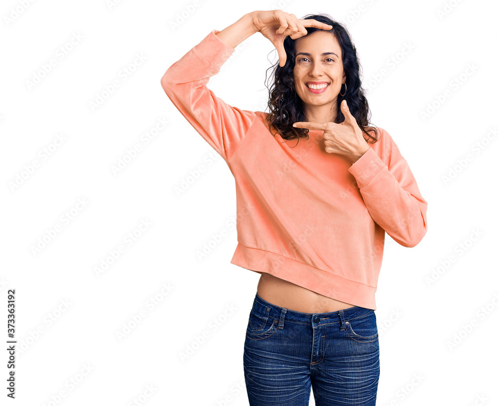 Young beautiful hispanic woman wearing casual clothes smiling making frame with hands and fingers with happy face. creativity and photography concept. Young beautiful hispanic woman wearing casual clothes smiling making frame with hands and fingers with happy face. creativity and photography concept.
