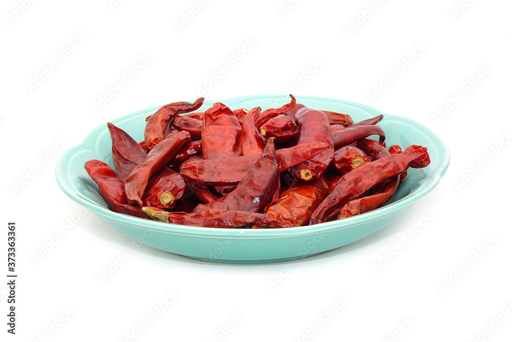 Dried red hot chili peppers on ceramic dish isolated on white background Dried red hot chili peppers on ceramic dish isolated on white background