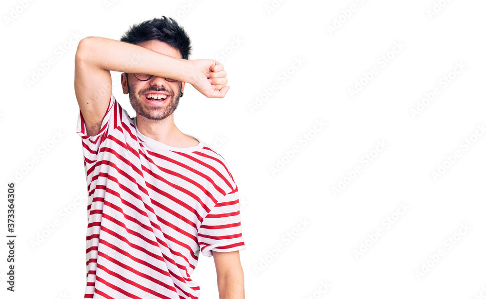 Young hispanic man wearing casual clothes covering eyes with arm smiling cheerful and funny. blind concept. Young hispanic man wearing casual clothes covering eyes with arm smiling cheerful and funny. blind concept.