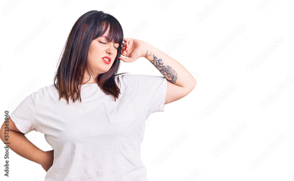 Young plus size woman wearing casual clothes stretching back, tired and relaxed, sleepy and yawning for early morning Young plus size woman wearing casual clothes stretching back, tired and relaxed, sleepy and yawning for early morning