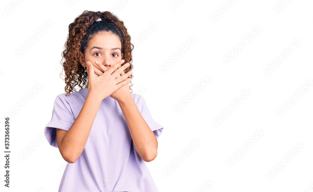 Beautiful kid girl with curly hair wearing casual clothes shocked covering mouth with hands for mistake. secret concept. Beautiful kid girl with curly hair wearing casual clothes shocked covering mouth with hands for mistake. secret concept.