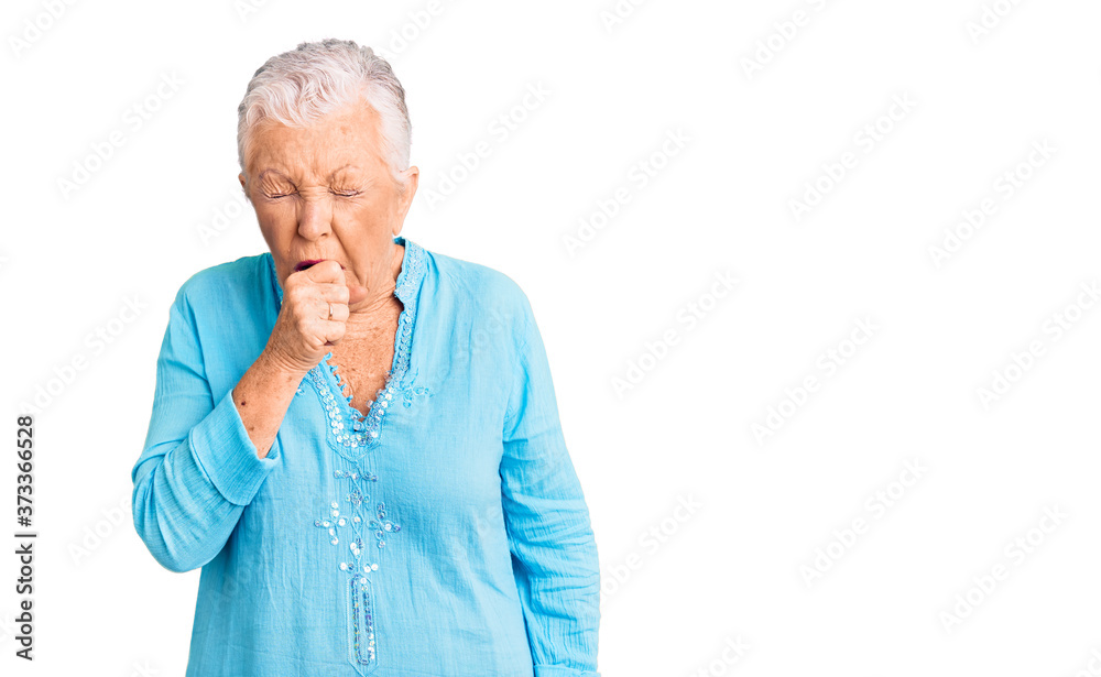 Senior beautiful woman with blue eyes and grey hair wearing summer dress feeling unwell and coughing as symptom for cold or bronchitis. health care concept. Senior beautiful woman with blue eyes and grey hair wearing summer dress feeling unwell and coughing as symptom for cold or bronchitis. health care concept.