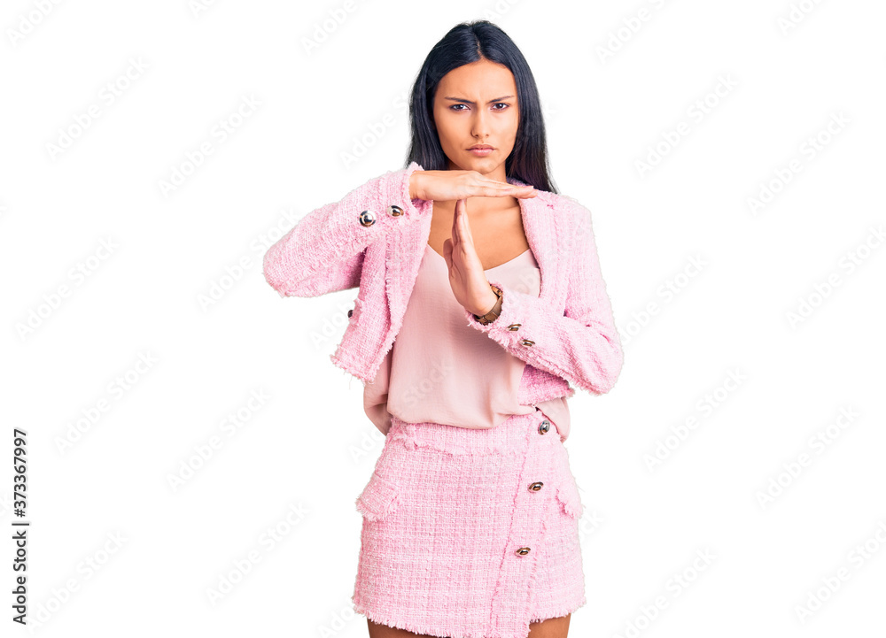 Young beautiful latin girl wearing business clothes doing time out gesture with hands, frustrated and serious face Young beautiful latin girl wearing business clothes doing time out gesture with hands, frustrated and serious face