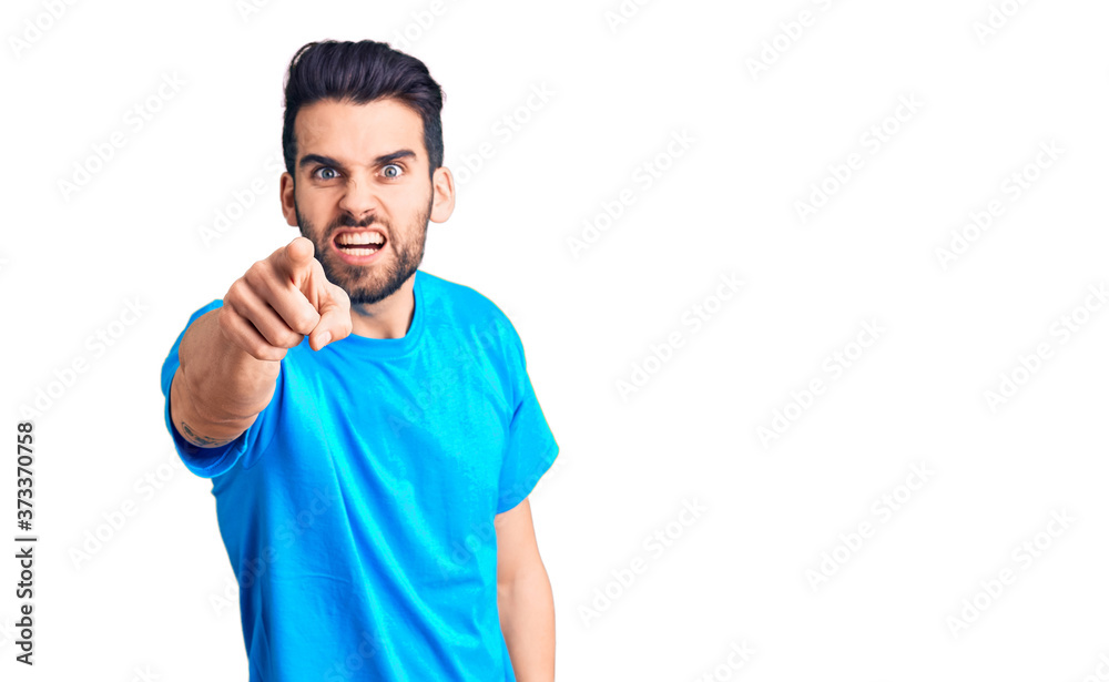Young handsome man with beard wearing casual t-shirt pointing displeased and frustrated to the camera, angry and furious with you Young handsome man with beard wearing casual t-shirt pointing displeased and frustrated to the camera, angry and furious with you