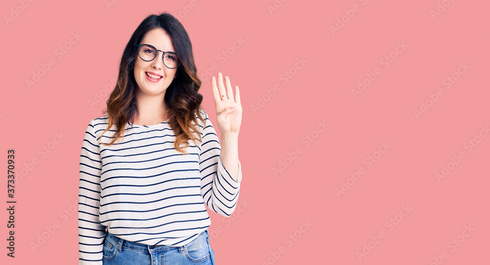 Beautiful young brunette woman wearing casual clothes and glasses showing and pointing up with fingers number four while smiling confident and happy. Beautiful young brunette woman wearing casual clothes and glasses showing and pointing up with fingers number four while smiling confident and happy.