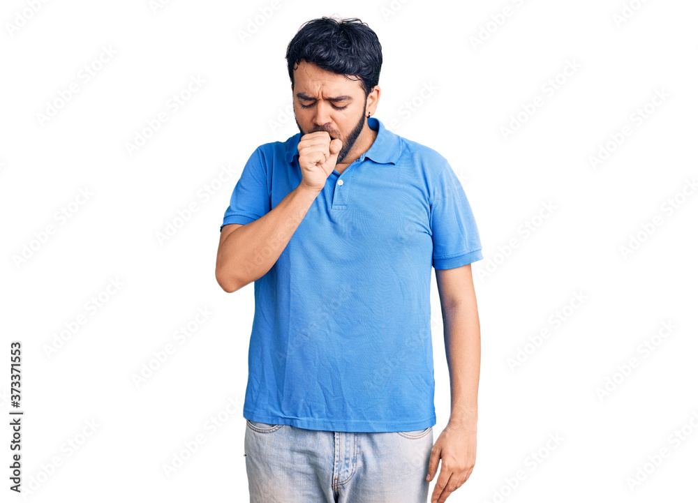 Young hispanic man wearing casual clothes feeling unwell and coughing as symptom for cold or bronchitis. health care concept. Young hispanic man wearing casual clothes feeling unwell and coughing as symptom for cold or bronchitis. health care concept.
