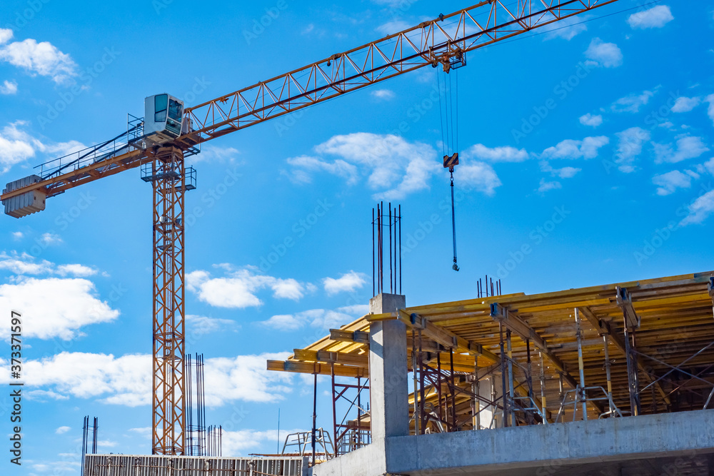 Tower construction crane. Fragment of a tower crane against the sky. Construction of buildings. Concept - construction business. Work as a crane operator. Career in the building business. Tower construction crane. Fragment of a tower crane against the sky. Construction of buildings. Concept - construction business. Work as a crane operator. Career in the building business.