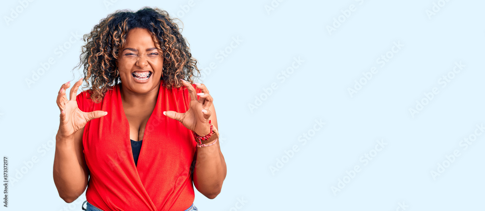 Young african american plus size woman wearing casual style with sleeveless shirt smiling funny doing claw gesture as cat, aggressive and sexy expression Young african american plus size woman wearing casual style with sleeveless shirt smiling funny doing claw gesture as cat, aggressive and sexy expression