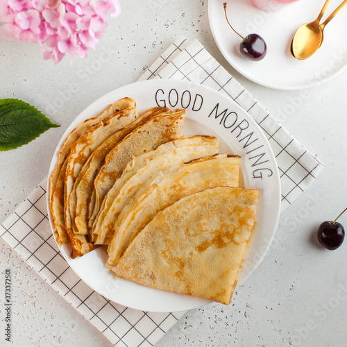 Delicious crepes on plates. Concept of Breakfast, dessert, recipe, French cuisine, Maslenitsa. Good morning photo