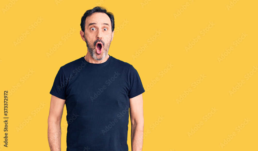 Middle age handsome man wearing casual t-shirt afraid and shocked with surprise expression, fear and excited face. Middle age handsome man wearing casual t-shirt afraid and shocked with surprise expression, fear and excited face.