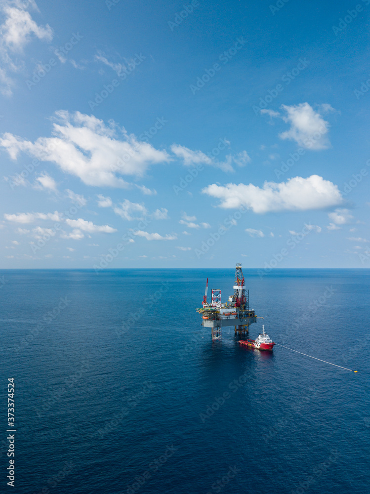 Aerial view from a drone of an offshore jack up rig at the offshore location during day time Aerial view from a drone of an offshore jack up rig at the offshore location during day time