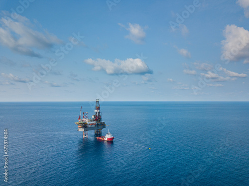 Aerial view from a drone of an offshore jack up rig at the offshore location during day time © bomboman