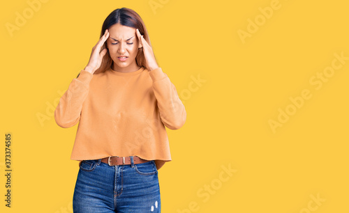 Beautiful young woman wearing casual clothes with hand on head for pain in head because stress. suffering migraine.