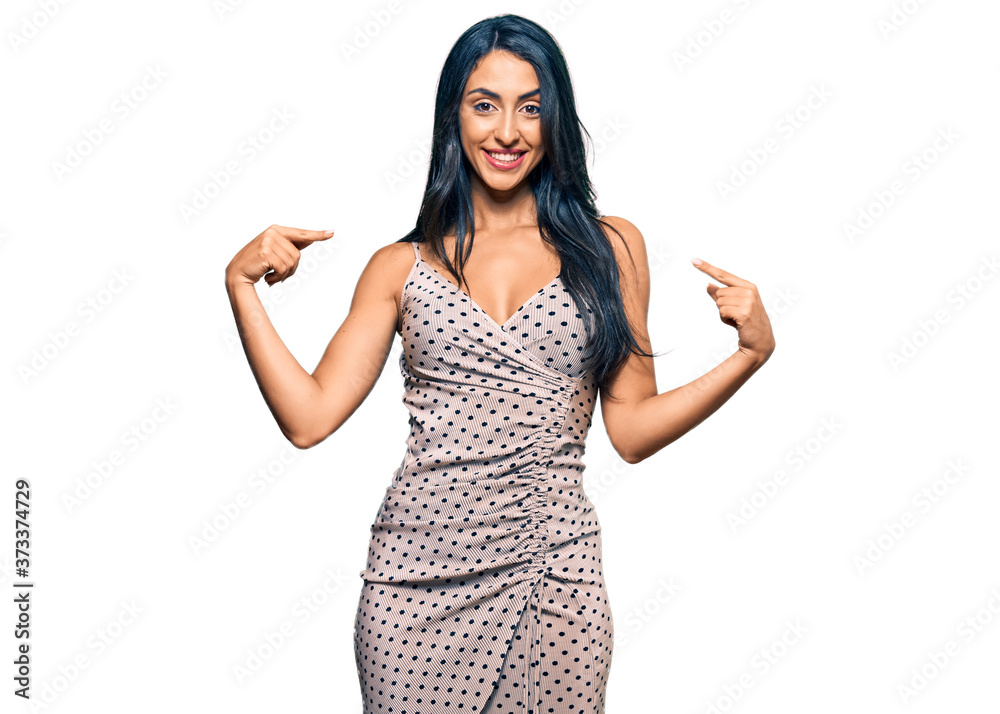 Beautiful hispanic woman wearing summer dress looking confident with smile on face, pointing oneself with fingers proud and happy. Beautiful hispanic woman wearing summer dress looking confident with smile on face, pointing oneself with fingers proud and happy.