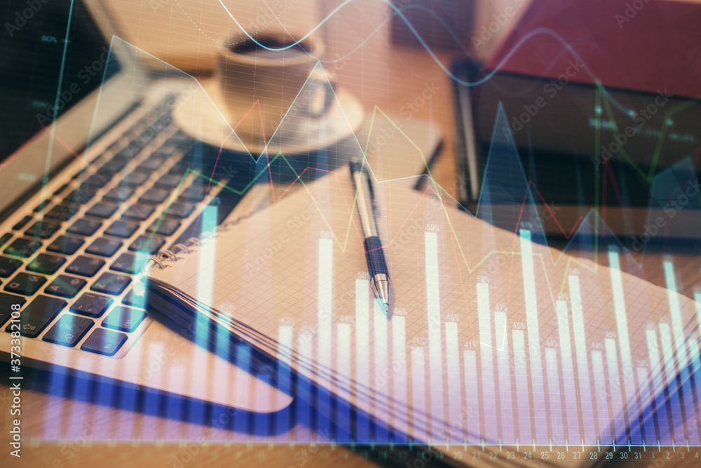 Double exposure of forex chart drawing and desktop with coffee and items on table background. Concept of financial market trading Double exposure of forex chart drawing and desktop with coffee and items on table background. Concept of financial market trading