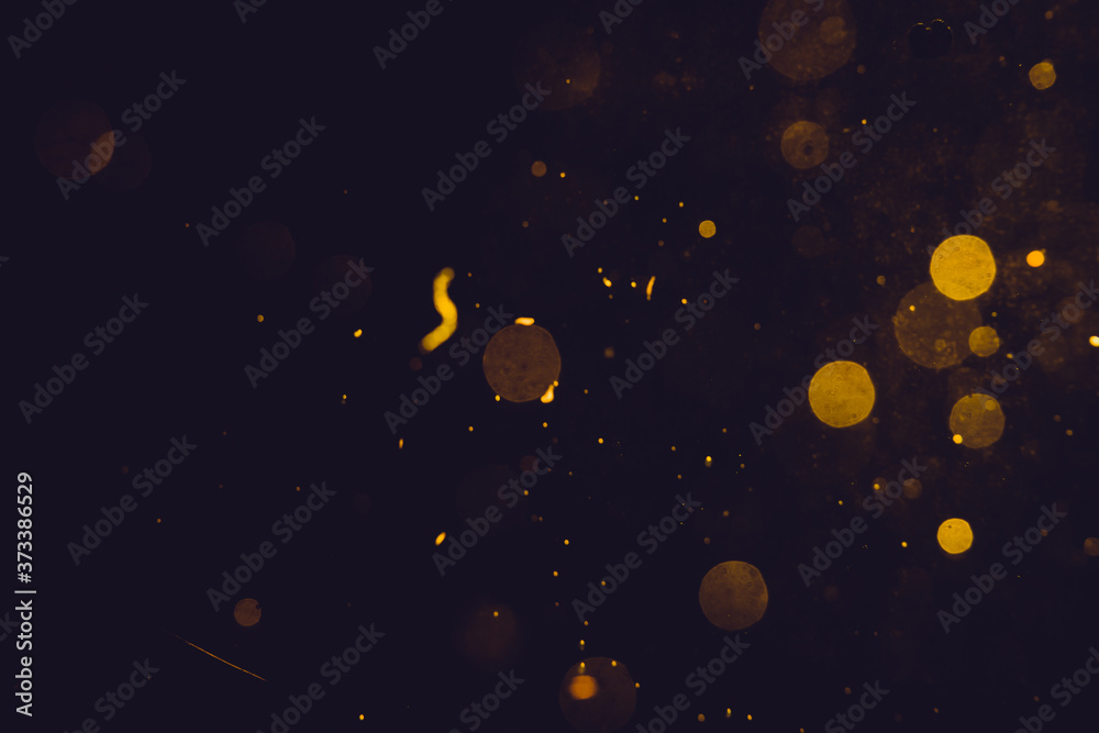 Naklejka premium Dark Abstract Gold bokeh sparkle on black