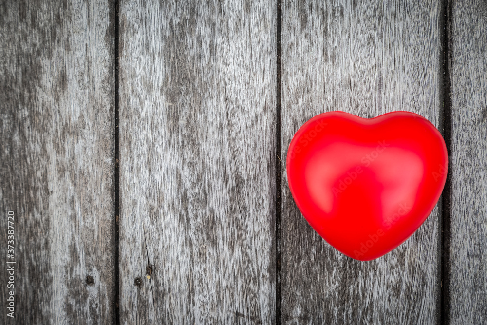 Red heart on wooden table Red heart on wooden table
