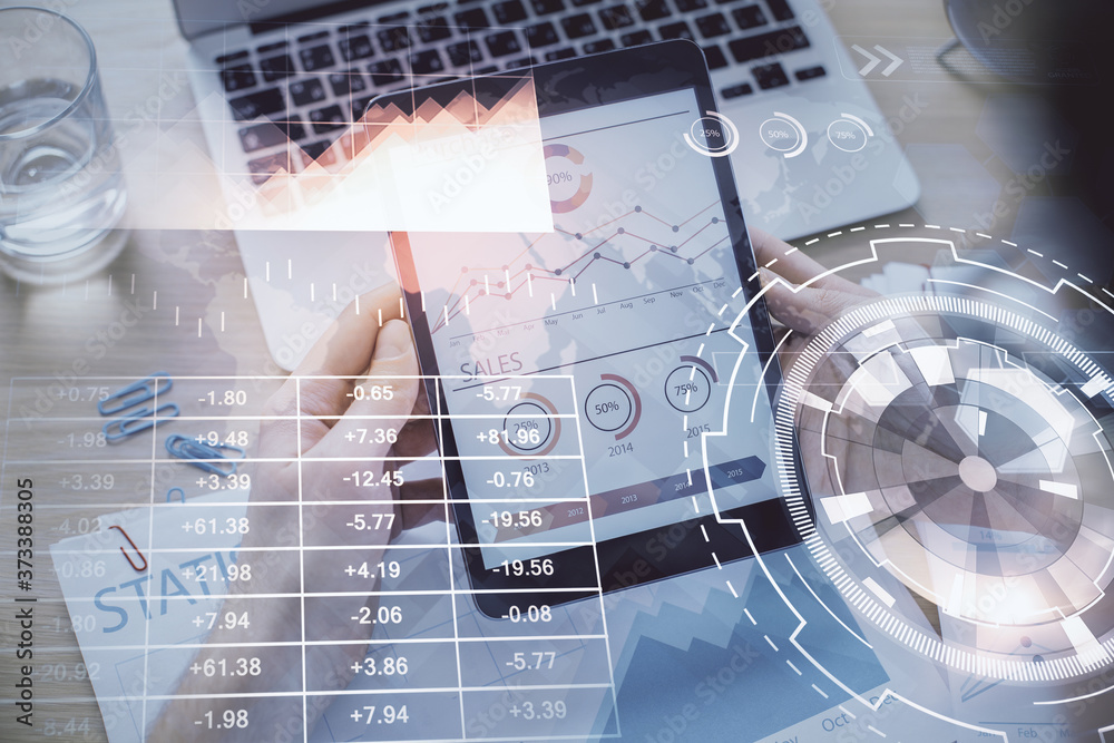 Double exposure of man's hands holding and using a digital device and forex graph drawing. Financial market concept. Double exposure of man's hands holding and using a digital device and forex graph drawing. Financial market concept.