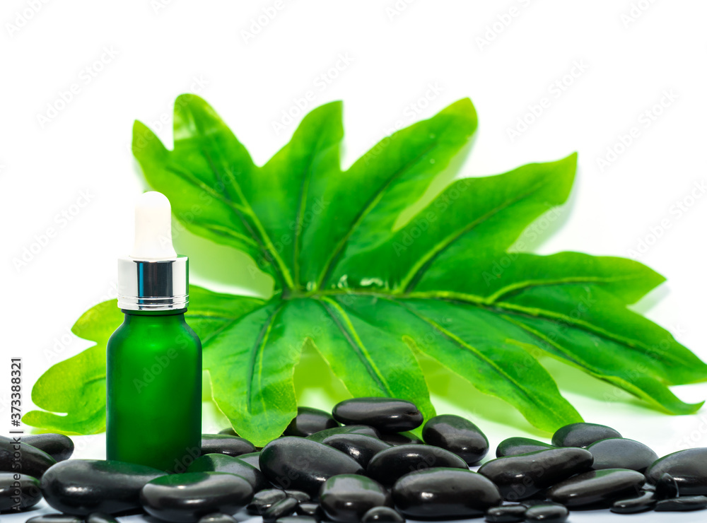 Serum oil bottle dropper for essential oils on black stone Serum oil bottle dropper for essential oils on black stone