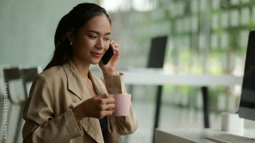 Close up view of female talking on the phone while take a coffee break