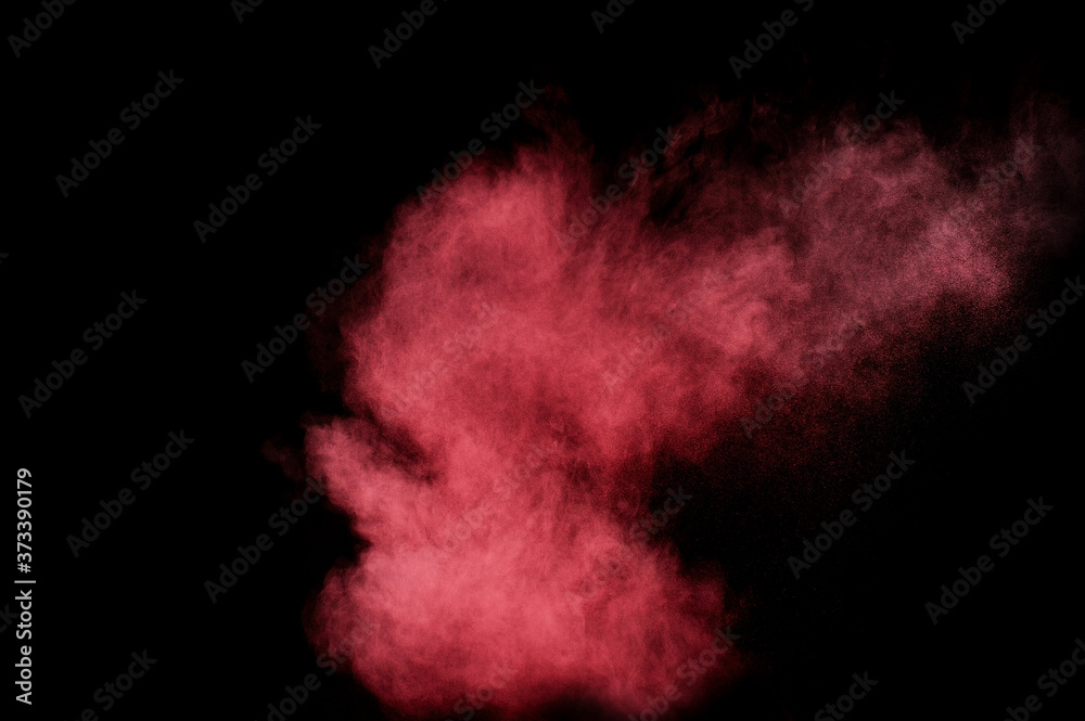 Fototapeta premium Red and pink powder explosion on black background. Colored powder cloud. Colorful dust explode. Paint Holi.