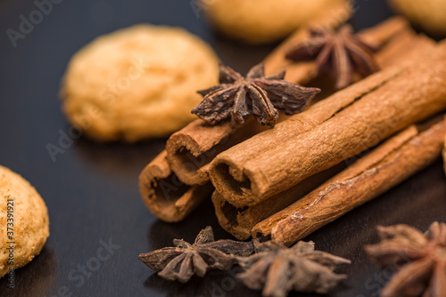 Traditional Christmas spices - Star anise with cinnamon and cloves on dark rustic wooden background