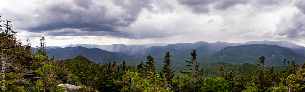 Panorama of scattered rain showers moving east over the Presidentail Range of the White Mountains, towards Boncliff