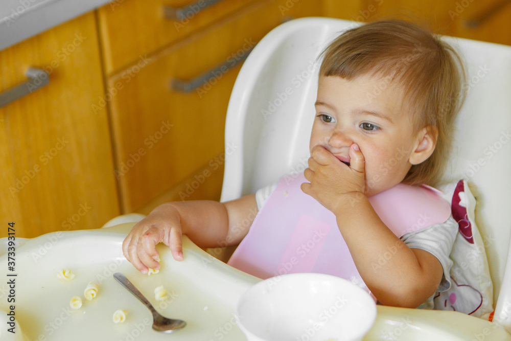 portrait of a child who eats baby food with his spoon. my face is smeared with food portrait of a child who eats baby food with his spoon. my face is smeared with food