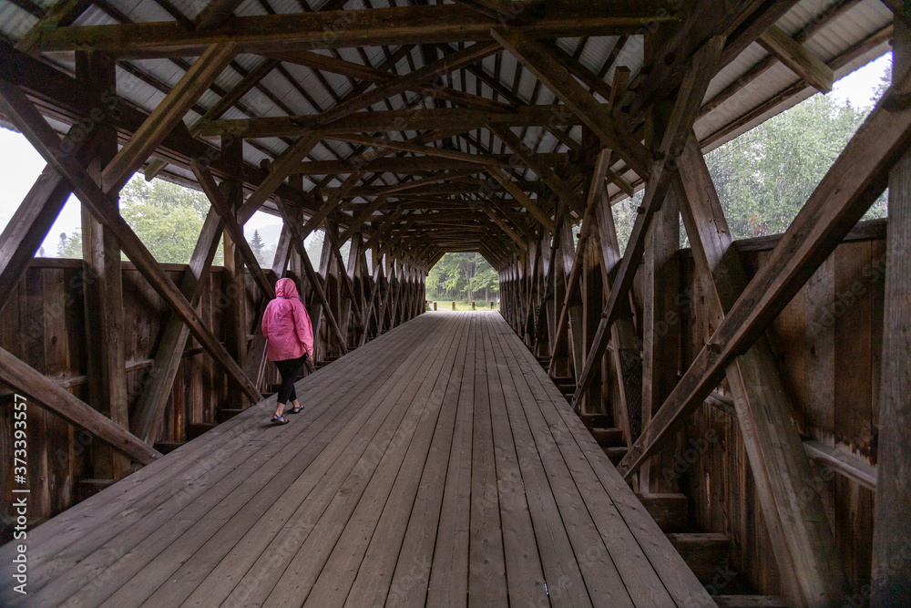 Walking across New England's covered bridges is a serene experience, evoking images of history among the wooden beams.