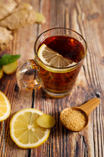 Lemon ginner tea with sliced fresh lemon and honey sugar