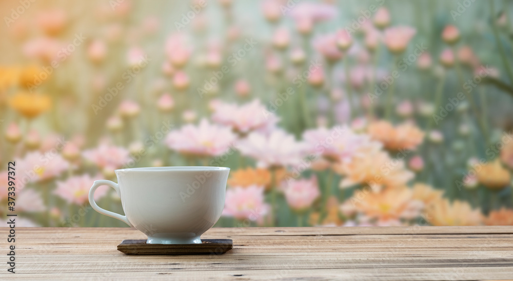 coffee cup on wooden table with flower background coffee cup on wooden table with flower background