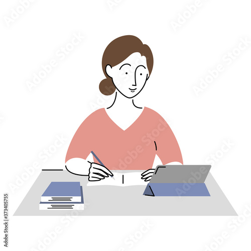 タブレットを見ながら勉強をする女性