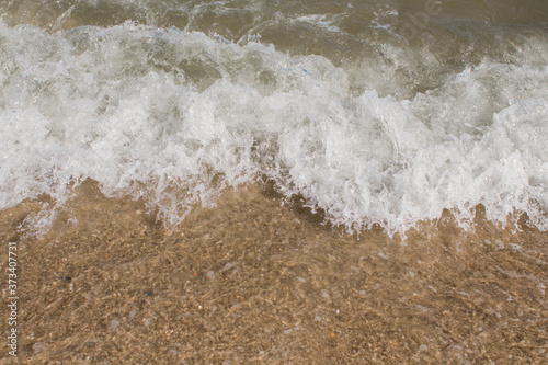 sea waves on a sandy shore in the afternoon