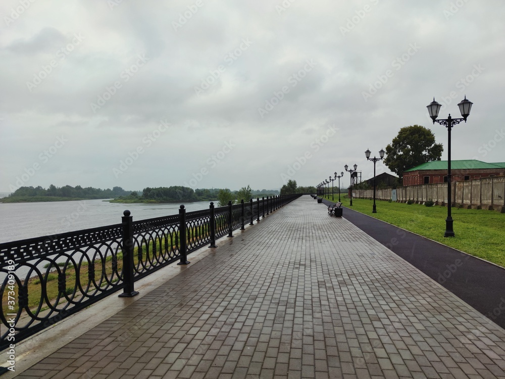 empty embankment after rain on gray sky background