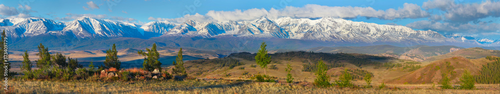 Large panorama, view of the snow-covered mountain range. Traveling in the mountains, hiking. Large panorama, view of the snow-covered mountain range. Traveling in the mountains, hiking.